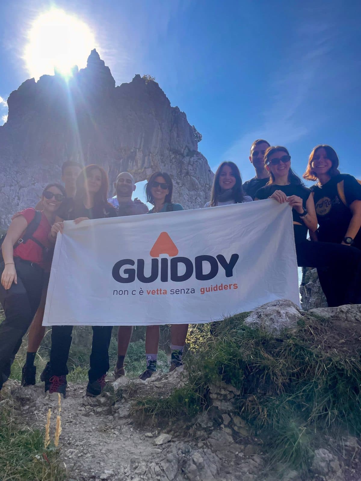 A group of young people with the Guiddy flag at Porta di Prada